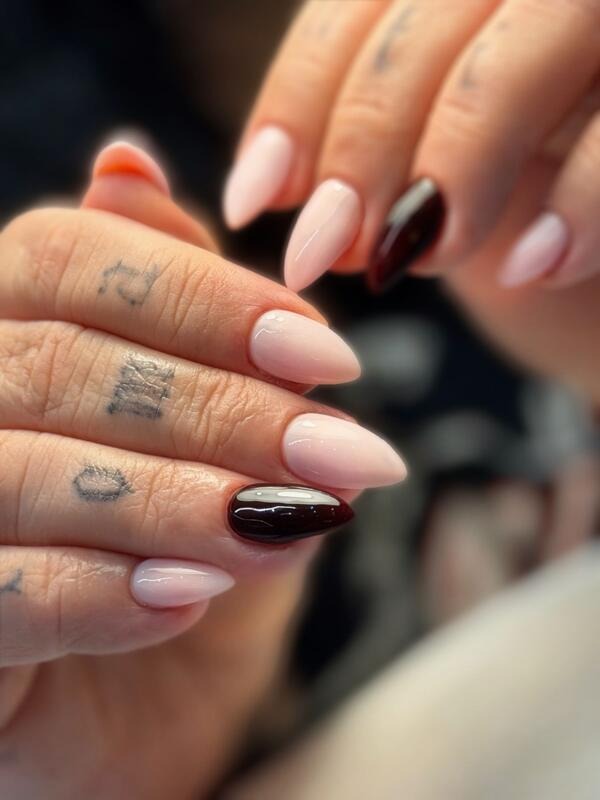 Long almond nails in soft pink with two deep burgundy accent nails